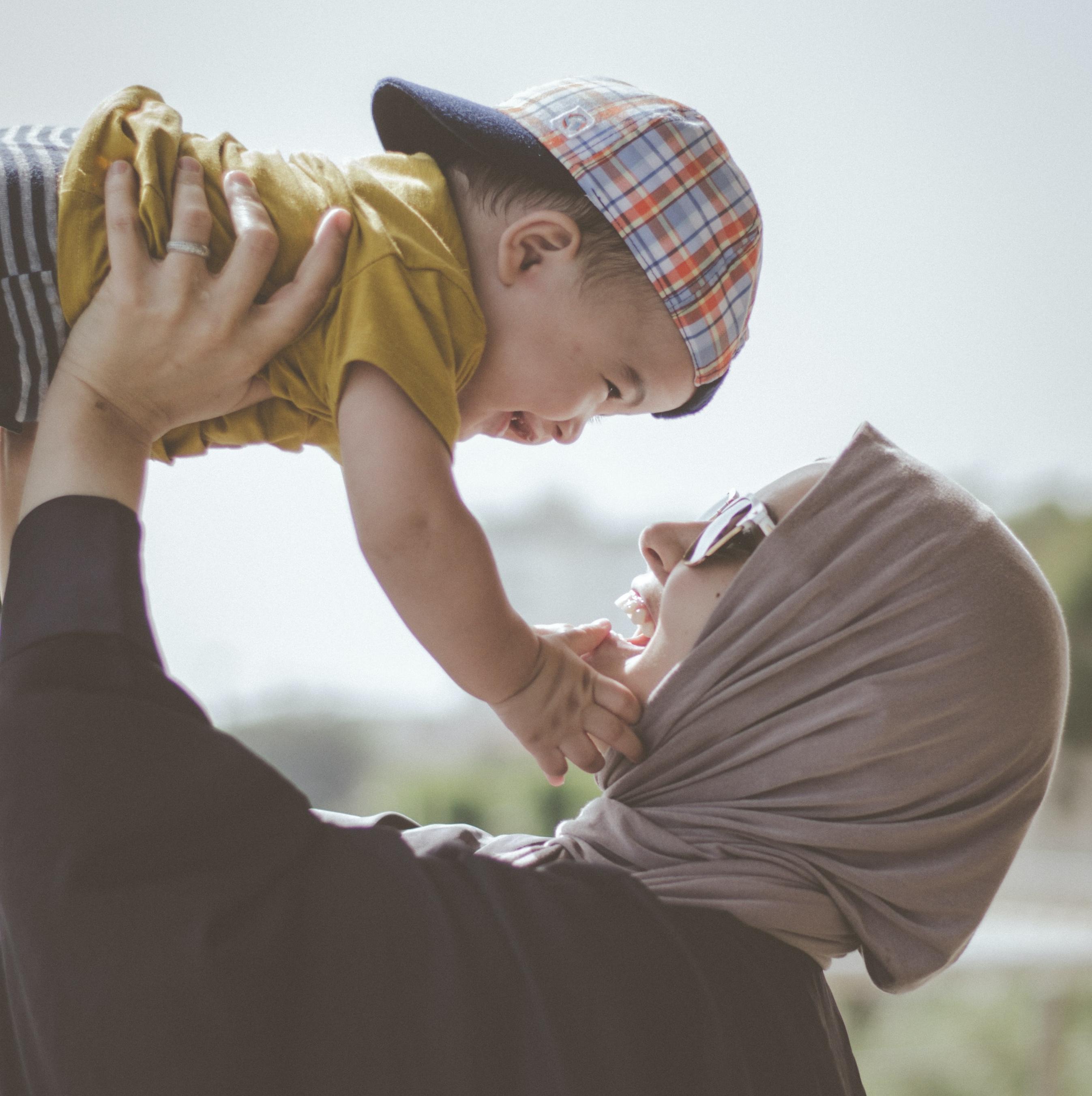 Image of a mother lifting her child