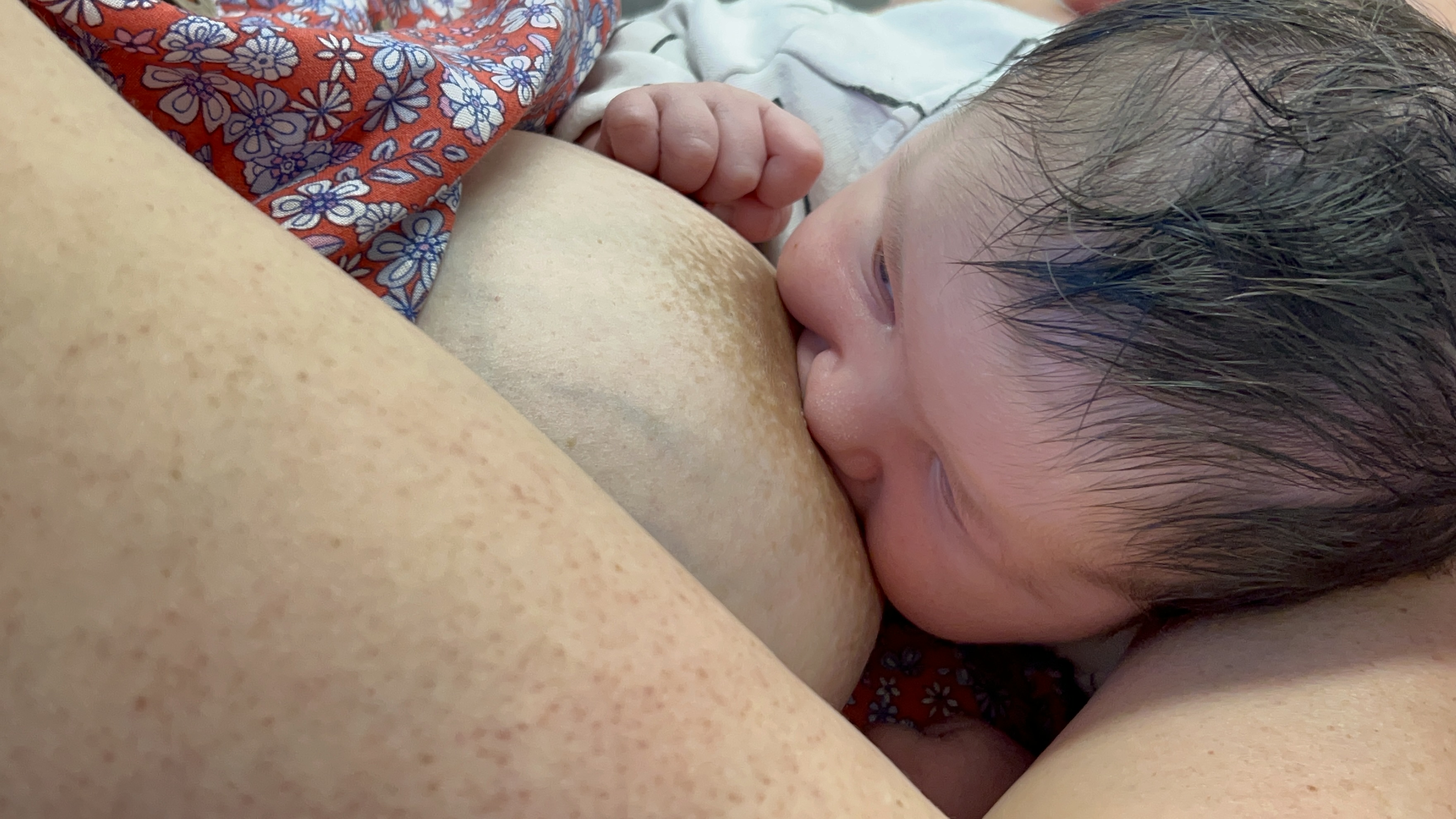 breastfeeding woman infant face-breast bury lateral view