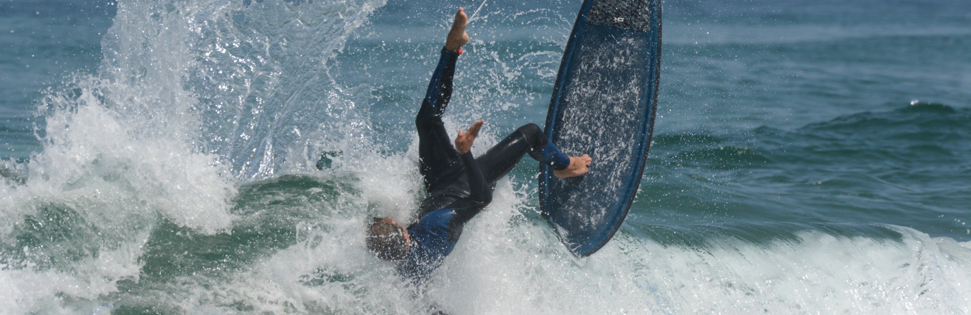 surfer falling off their surfboard