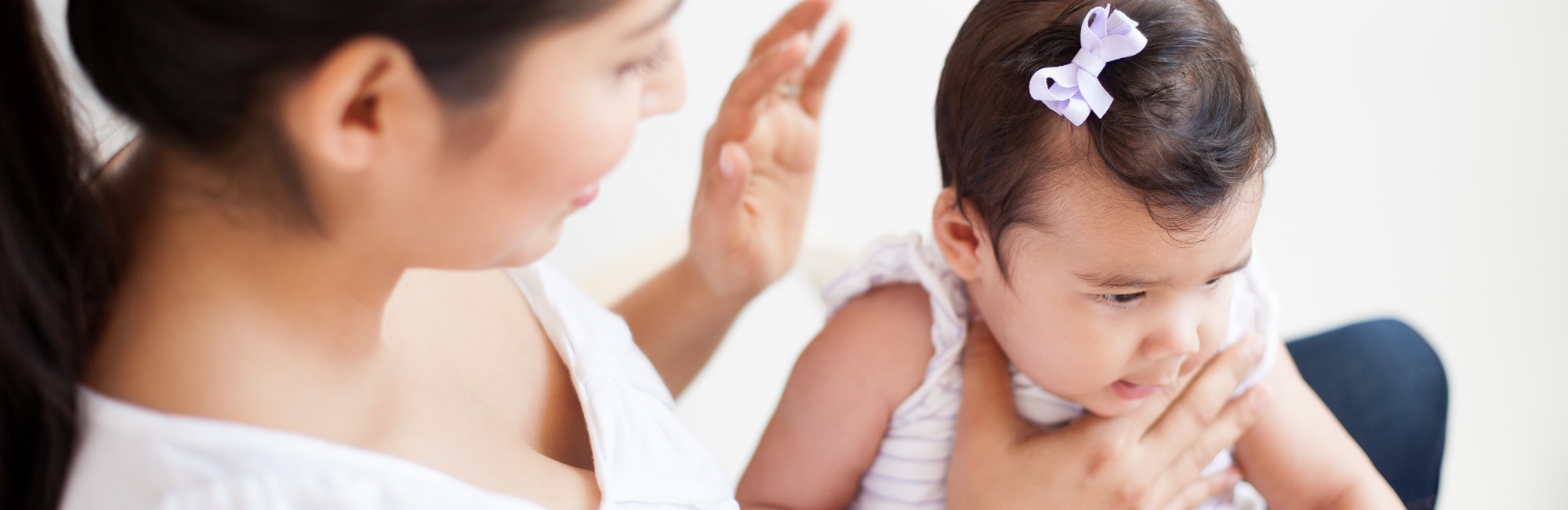 a mother burping her baby