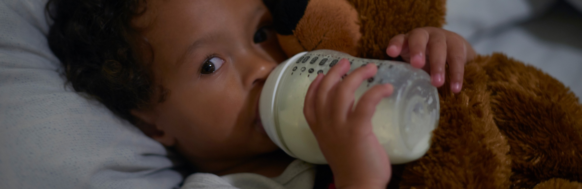 toddler drinking milk from bottle