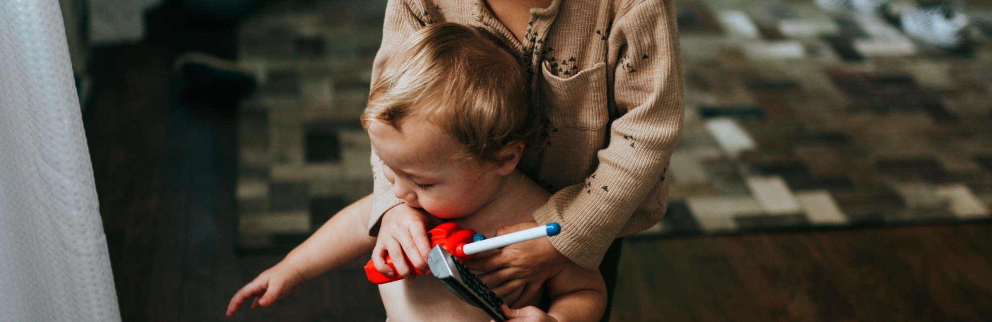older child plays with toddler in the evening