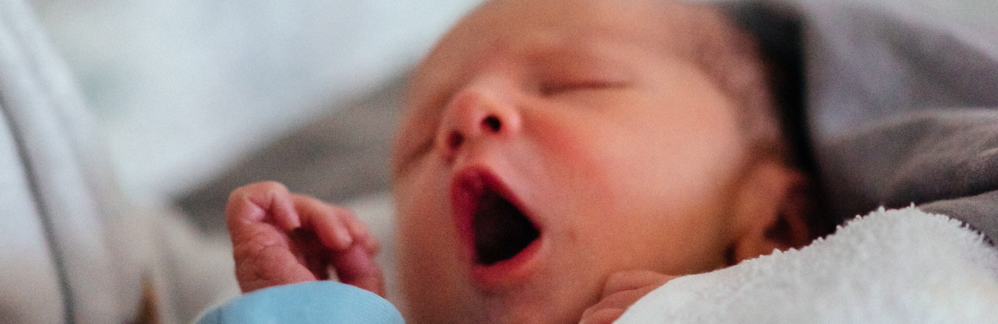 Yawning newborn baby with out of sync body clock