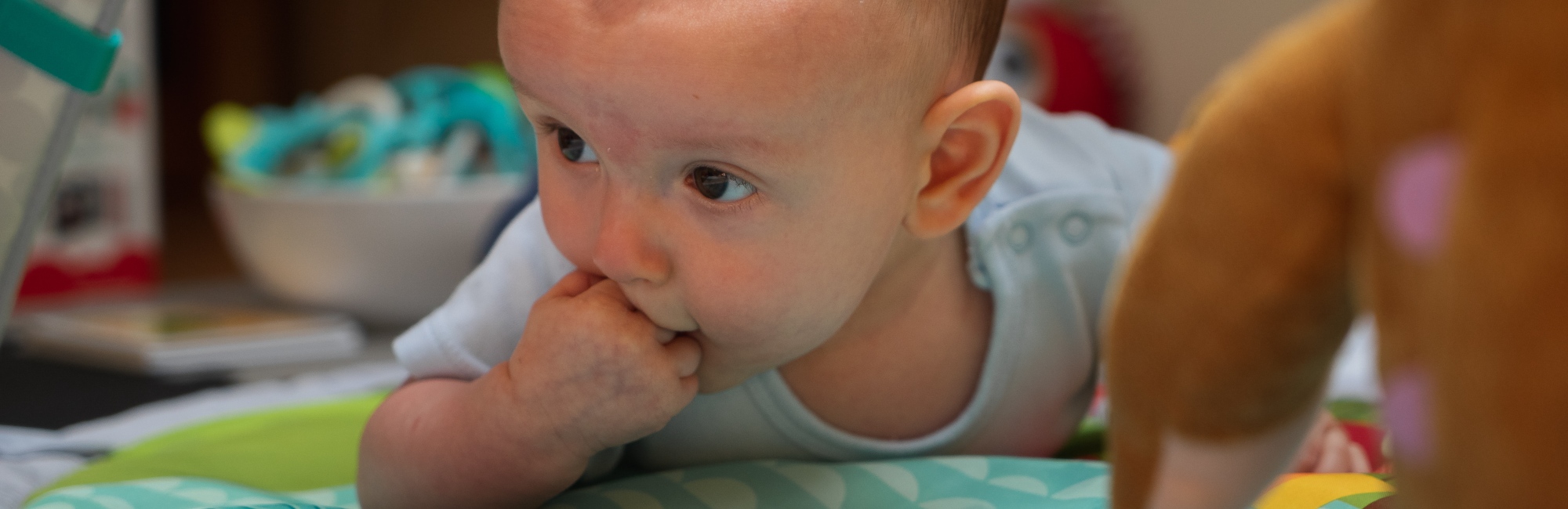 a baby plays while on its stomach