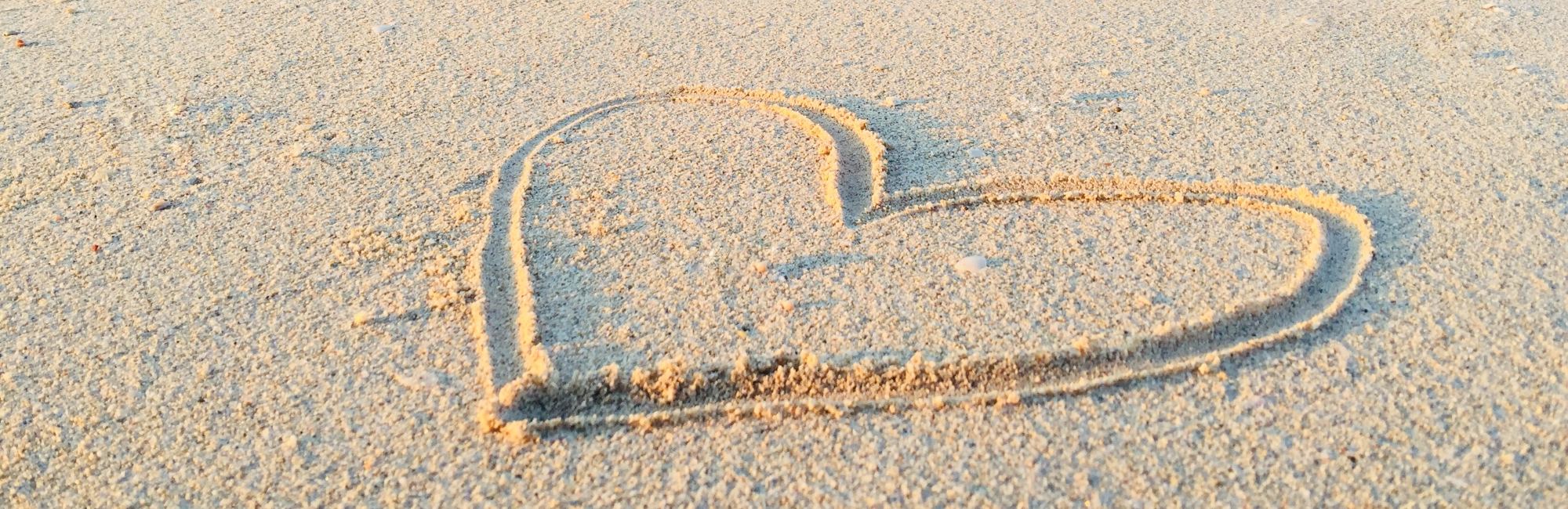 love heart drawn into sand