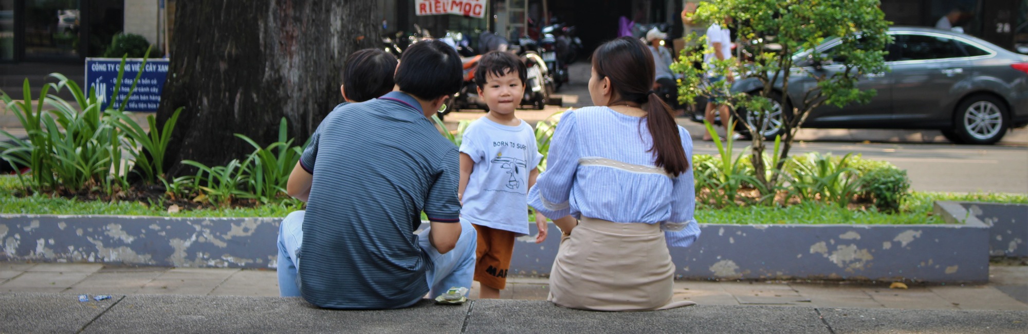 asian family playing outside on the street