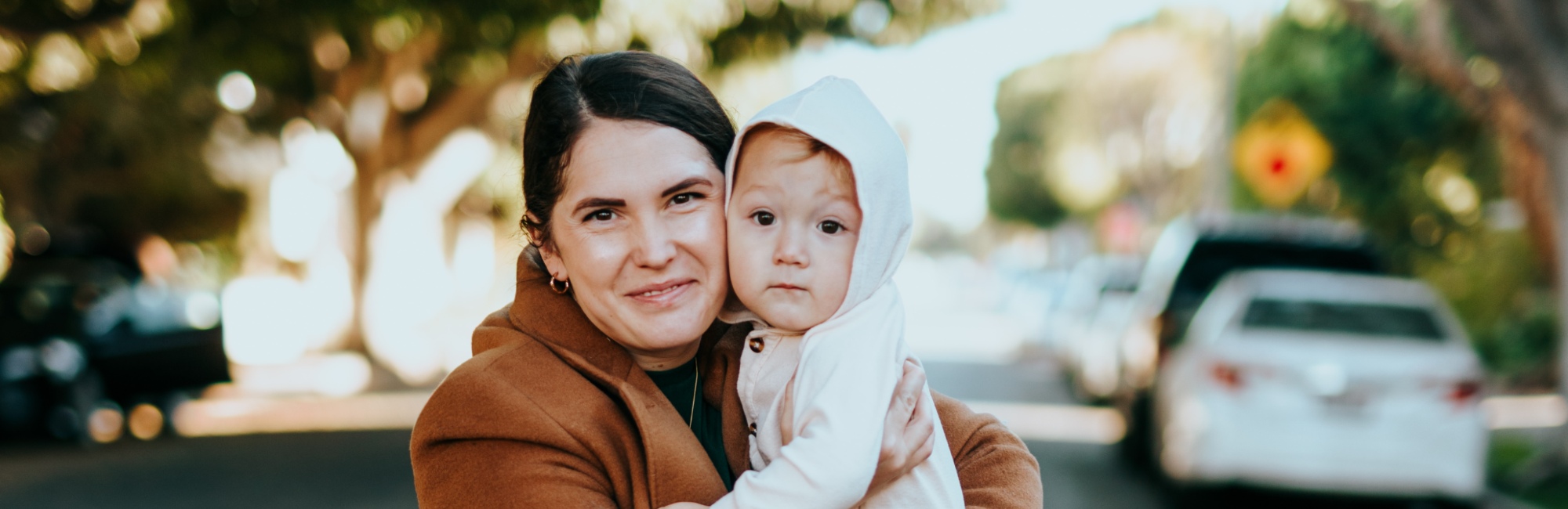 mother holding baby both looking at camera