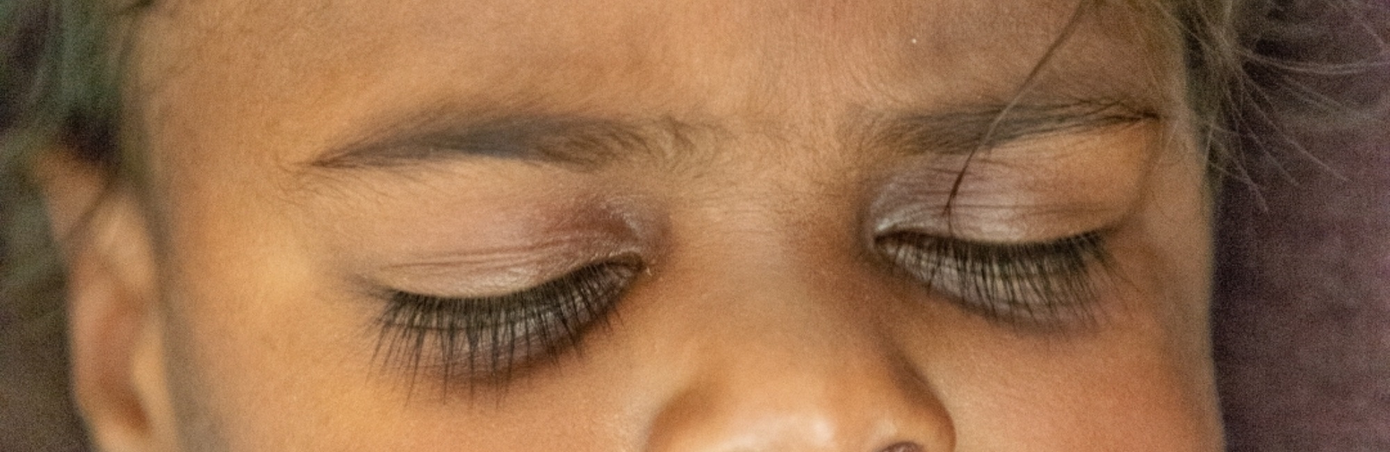 closeup of australian toddler with closed eyes sleeping