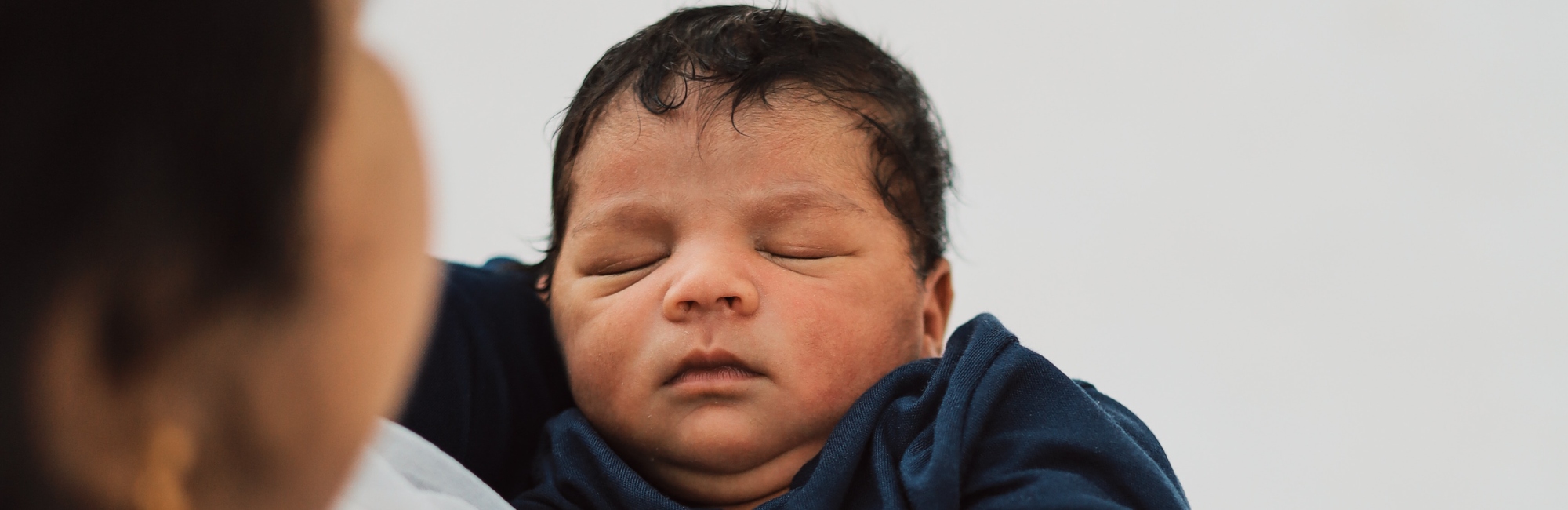 asian baby sleeping in blue blanket