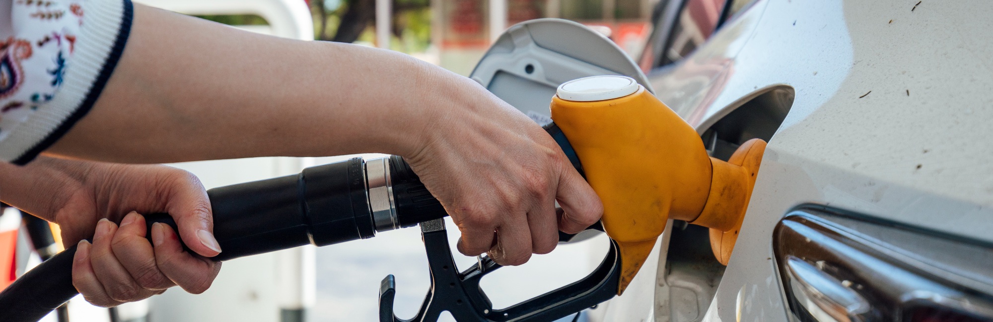 person filling up car's petrol tank