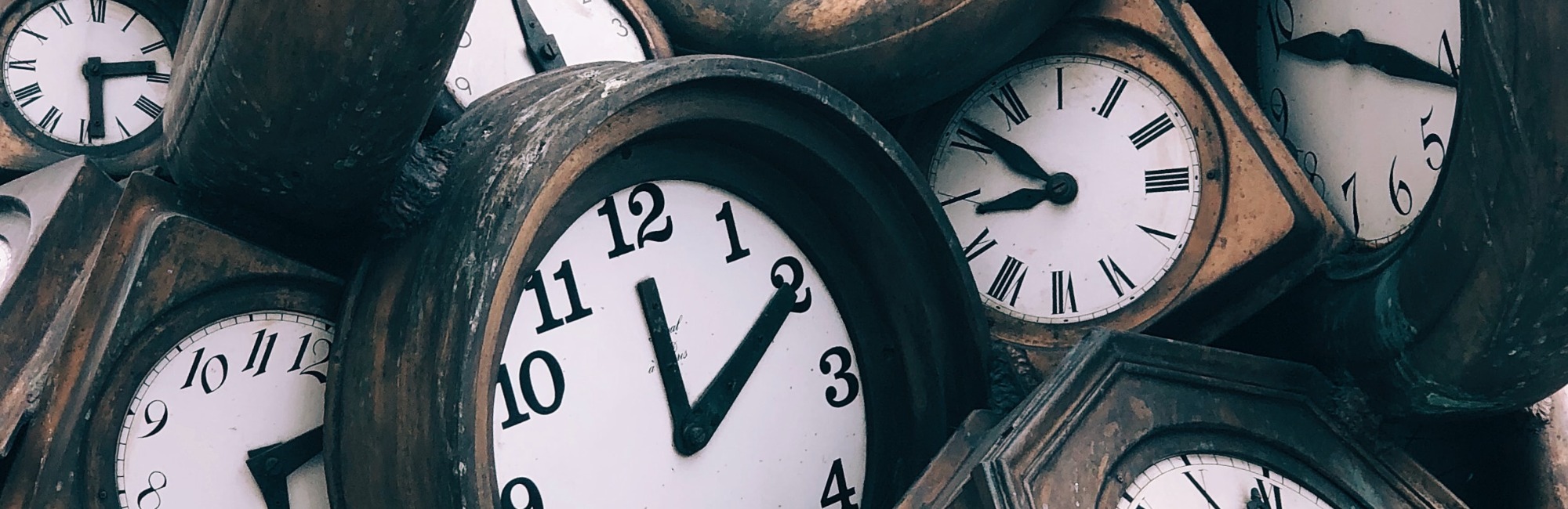 pile of old wooden clocks
