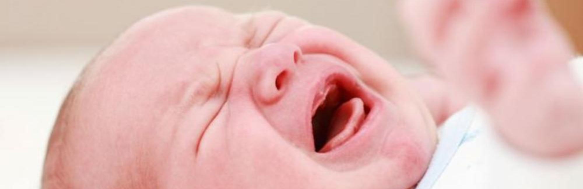 baby cries while lying on back